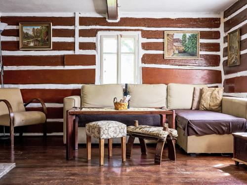 a living room with a couch and a table and chairs at Holiday Home U Myšáka by Interhome in Tanvald