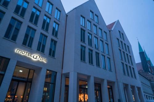 a building with the words hotel one at Motel One Lübeck in Lübeck