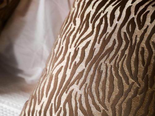 a close up of a zebra pattern on a pillow at Chalet Le Grillon by Interhome in Nendaz