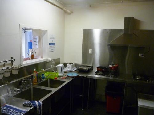a kitchen with a sink and a counter top at Adelaide Travellers Inn Backpackers Hostel in Adelaide