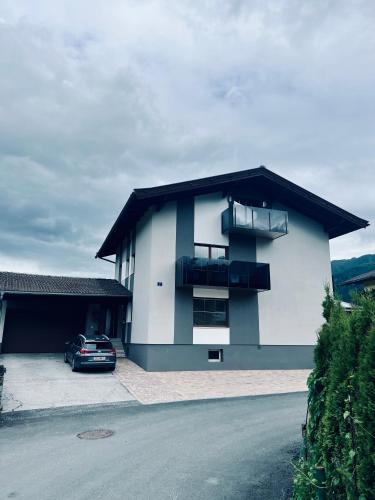 a house with a car parked in front of it at Mooslodge in Kaprun