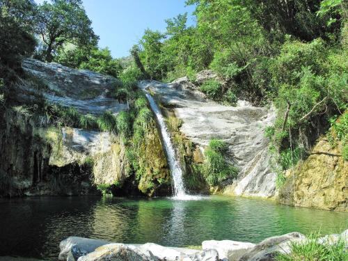 a waterfall in the middle of a pool of water at Apartment Verde - PTB151 by Interhome in Pietrabuona