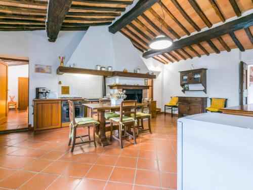a kitchen with a table and chairs in a room at Apartment Villi by Interhome in Montieri