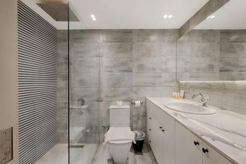 a bathroom with a toilet and a sink at VESTA - Nile View Residence in Cairo