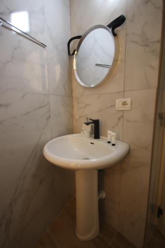 a bathroom with a sink and a mirror at Vila Bajrami in Vlorë