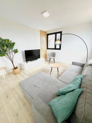a living room with a couch and a television at El Retiro in Las Palmas de Gran Canaria