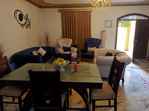 a living room with a table and chairs at Big pyramid view in Cairo