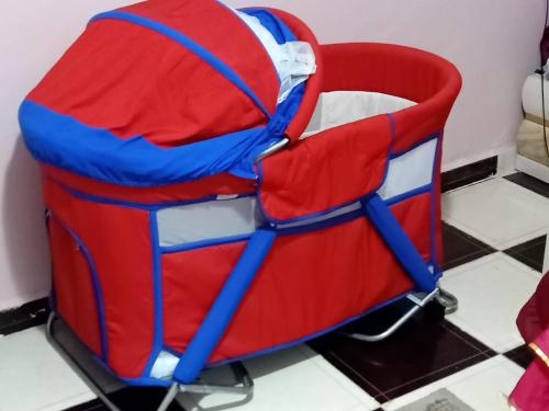 a red and blue chair sitting on a tiled floor at Big pyramid view in Cairo