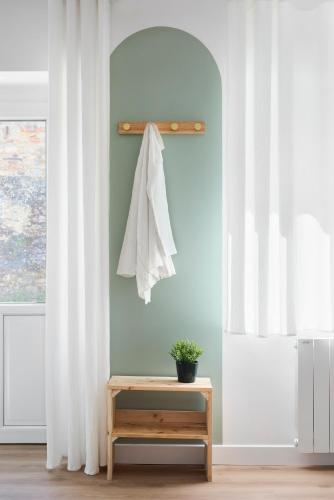 a room with white curtains and a table and a window at Le Duplex in Saint-Nicolas-de-Redon