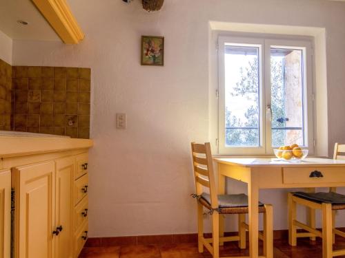 a kitchen with a table and chairs and a window at Holiday Home La Foux by Interhome in Tourrettes