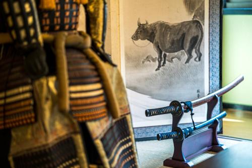 a wooden bench next to a picture of a cow at 春夏秋冬 in Hakone