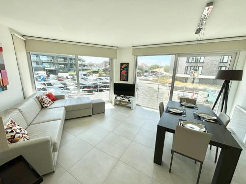 科克赛德La Croisette 0102的带沙发和桌子的客厅以及用餐室