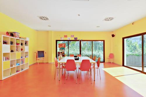 a dining room with yellow walls and a table and chairs at Impressive Playa Granada Golf in Motril