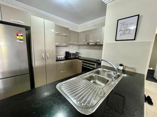 a kitchen with a sink in the middle of it at Blue Sky Gardens-minutes to JCU University &Townsville Hospital in Ross River