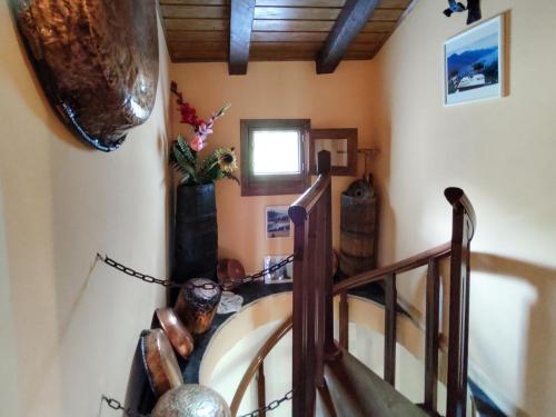 a spiral staircase in a room with a wooden ceiling at Apartment Mia e Giulia by Interhome in Dosso del Liro