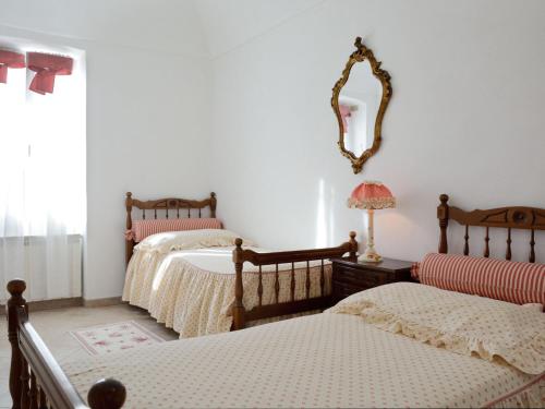 a bedroom with two beds and a mirror on the wall at Apartment Daniela - DOL295 by Interhome in Costa Carnara