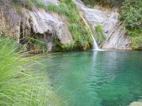 a pool of water next to a waterfall at Apartment Daniela - DOL295 by Interhome in Costa Carnara