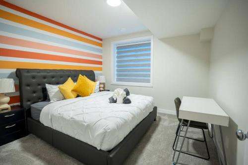 a bedroom with a bed with a stuffed animal on it at Warm getaway Perfect for 4 in Edmonton