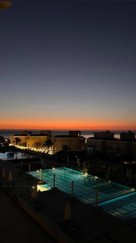 a view of a swimming pool at sunset at Serene Selena Bay Apartments in Hurghada