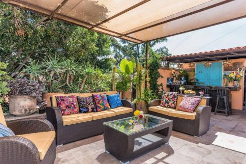an outdoor patio with couches and a table at La Pajarera prime location in San Miguel in San Miguel de Allende
