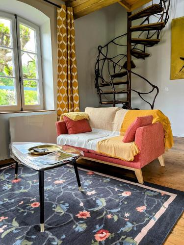 a living room with a couch and a table at Château d'Aigneville in Aigneville
