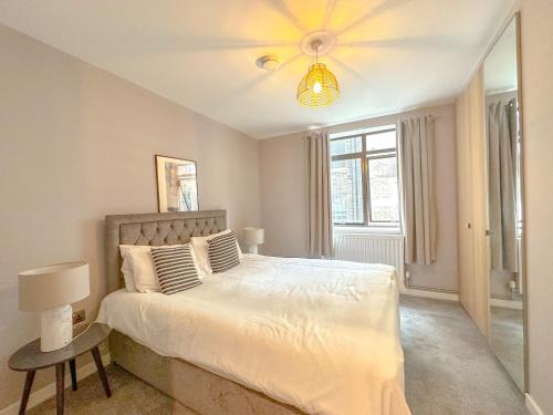a bedroom with a large bed and a mirror at Baker Street Apartments in London