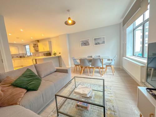a living room with a couch and a table at Baker Street Apartments in London