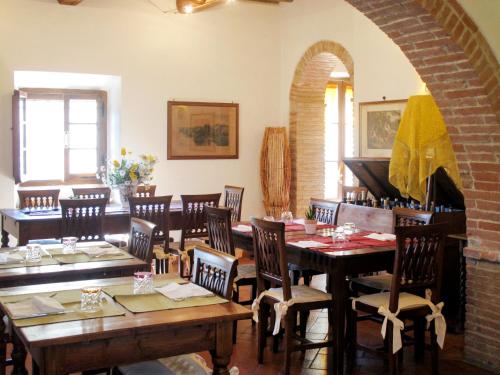 a dining room with wooden tables and chairs at Holiday Home Antico Borgo San Lorenzo by Interhome in Poggibonsi