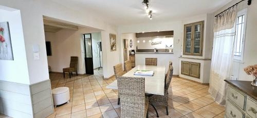 a kitchen and dining room with a table and chairs at Lou Mas dou Souleou & Spa in Cheval-Blanc