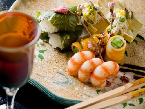 a plate of food with shrimp and a glass of wine at Suimeikan in Gero