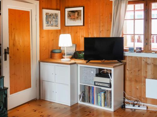 a living room with a television on a cabinet at Chalet Skeisvegen by Interhome in Svingvoll