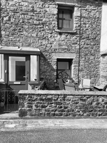 a stone building with a stone wall and a window at Pemberton cottage in Ingleton 