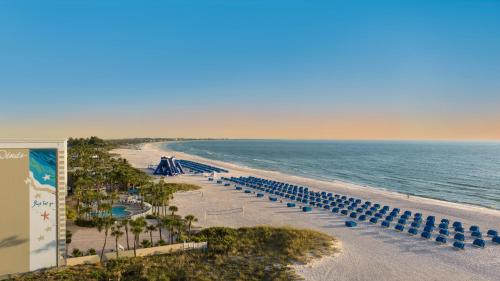 an aerial view of a beach with chairs and the ocean at Island Grand at TradeWinds in St Pete Beach