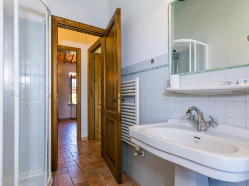 a bathroom with a sink and a mirror at Apartment Arancione by Interhome in Suvereto