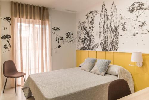 a bedroom with a bed with a yellow headboard at Casa para 8 personas con jardin in Palafolls