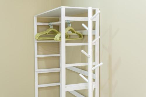 a closet with white shelves and hangers at Casa para 8 personas con jardin in Palafolls
