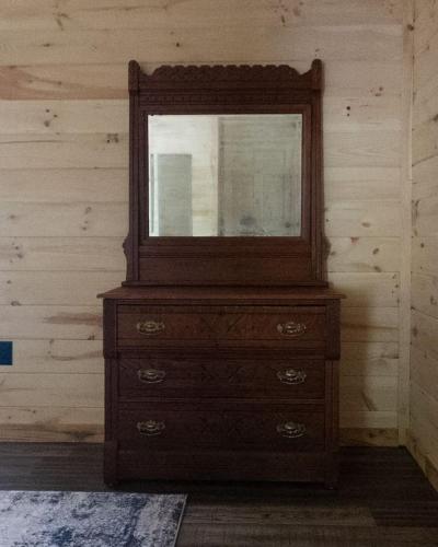a dresser with a mirror on top of it at Kentucky Coal Cabin 2 min from Lake Cumberland in Jamestown