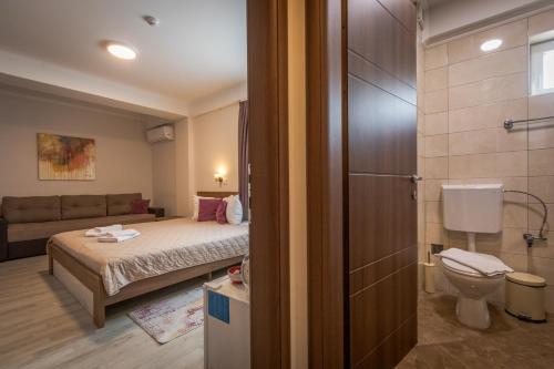 a small room with a bed and a bathroom at Boulevard Apartments in Gevgelija