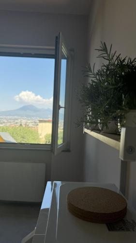a room with a window and a hat on a table at Villa C Luxury Estate in SantʼAntonio Abate