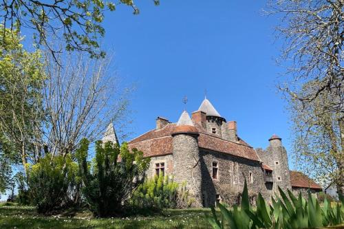 an old castle in the middle of a field at Villa le Roche du Ris - 10-12 personnes in Baraize
