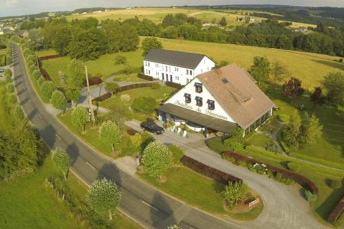 an aerial view of a large white house in a field at Le Panorama Nadrin in Nadrin