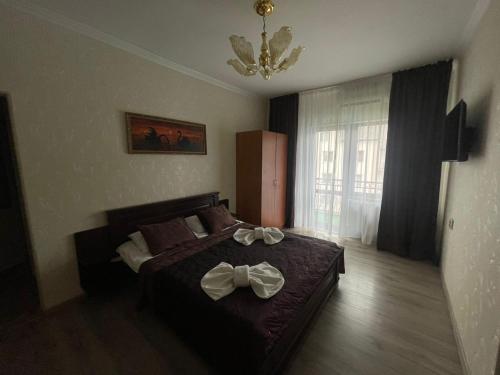 a bedroom with a bed with bows on it at Сонячна Перлина in Polyana