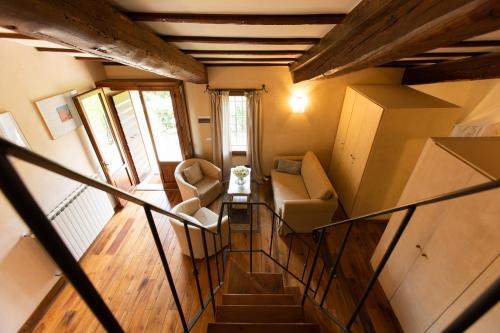 a room with a staircase with chairs and a window at Agriturismo Fattoria Lavacchio in Pontassieve