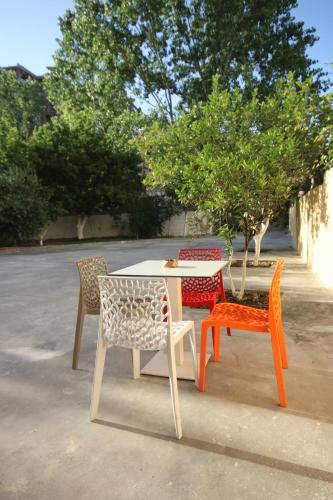 four chairs and a table and a table and chairs at Vila Bajrami in Vlorë
