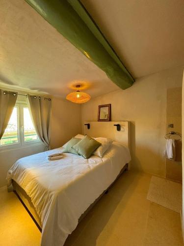 une chambre avec un grand lit blanc dans une pièce dans l'établissement Appartement Lumineux Avignon Intra-muros au calme, à Avignon