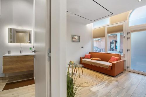 a living room with a couch and a sink at Maison Bijoux Aosta in Aosta
