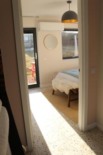 a bedroom with a bed and a window and a mirror at Hector's Row in Tobermory