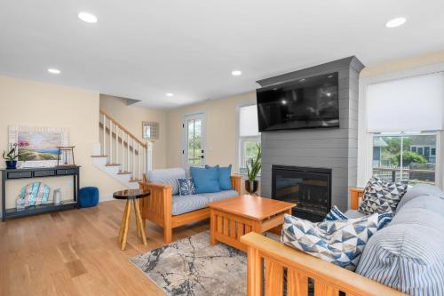 a living room with a couch and a fireplace at 37 Clam Shell Drive Chatham - Slow M'Ocean in Chatham