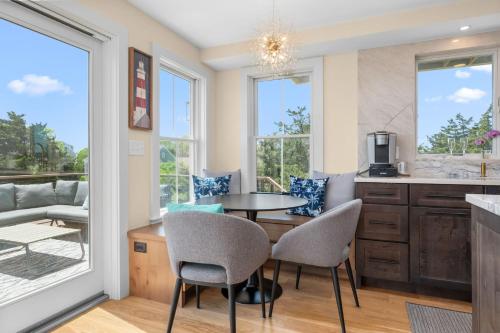 a kitchen and dining room with a table and chairs at 37 Clam Shell Drive Chatham - Slow M'Ocean in Chatham