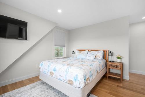a bedroom with a bed and a tv at 37 Clam Shell Drive Chatham - Slow M'Ocean in Chatham